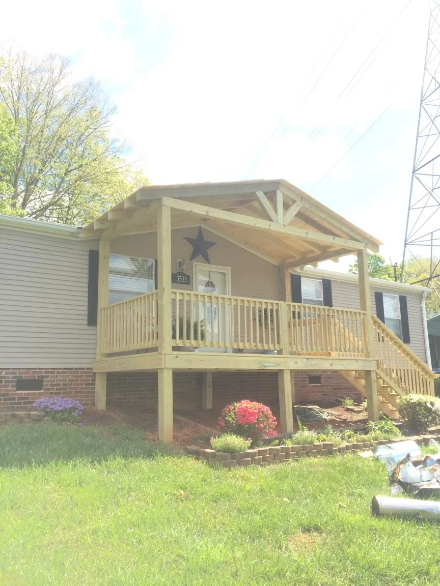New gabled porch roof and deck railing added to a ranch home in Stockton